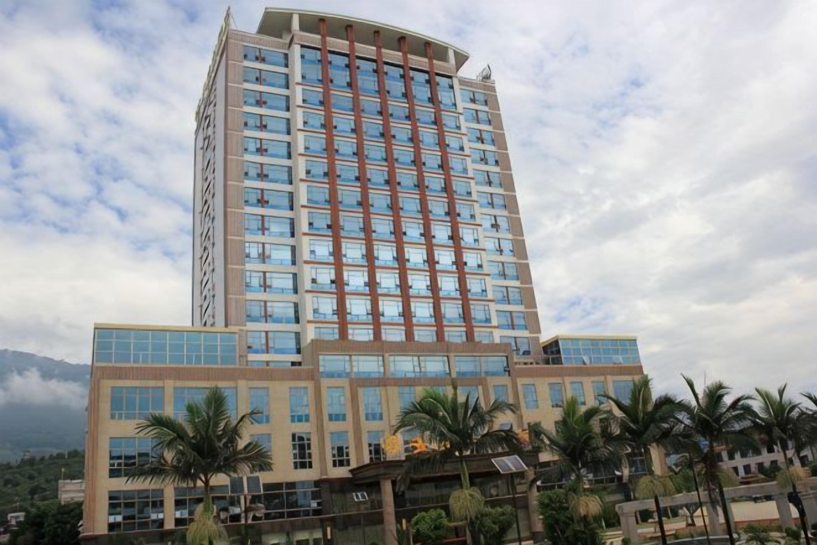 A multi-story hotel with a modern design, featuring a prominent central tower and a flat facade with large windows.