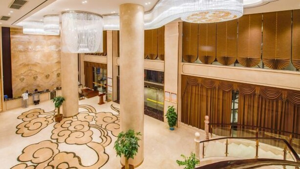 A spacious lobby with a marble floor, large columns, and a staircase. - Tianbaolong Hotel (Fusui)