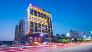 A multi-story hotel with illuminated signage and a prominent entrance. - Tianbaolong Hotel (Fusui)