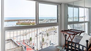 Ein Balkon mit Blick auf das Meer und eine Stadt.
