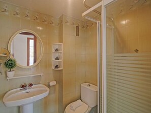 A bathroom with a sink, mirror, toilet, and shower. - Apolo IV by Interhome (Calpe/Calp)