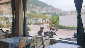A restaurant with a view of a street and buildings. - Shengsi Haiwang Mingzhu Homestay (Shengsi)