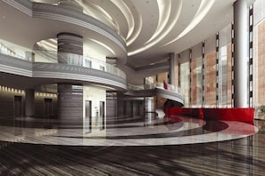 A spacious atrium with a circular floor plan, multiple levels, and a central open area. - Central Business Apartment Hotel (Kunshan)