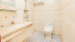 A bathroom with a white sink, a toilet, and a shower area. - Hengyang Environmental Protection Hotel (Hengyang)