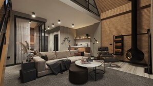 Una sala de estar moderna con sofá, mesa de centro y reposapiés, una zona de cocina con estufa integrada y una chimenea.