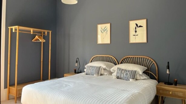 A bedroom with a bed, bedside tables, a hanging light fixture, and two wall-mounted pictures. - Field Maple -free parking -Grade Ii listed- first (Huntingdon)