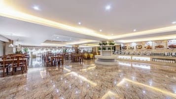 A spacious lobby with a polished marble floor, a central reception area, and a variety of seating arrangements.