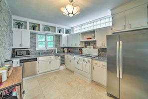 A modern kitchen with white cabinets, stainless steel appliances, and a granite countertop. - Sugar Shores ~ 3 Mi to Indiana Dunes Nat'l Park (Chesterton)