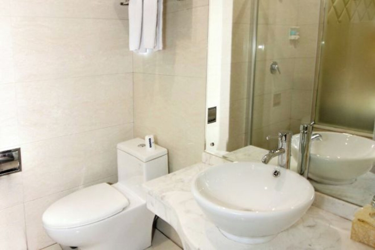 A modern bathroom with a toilet, a sink, and a shower area.