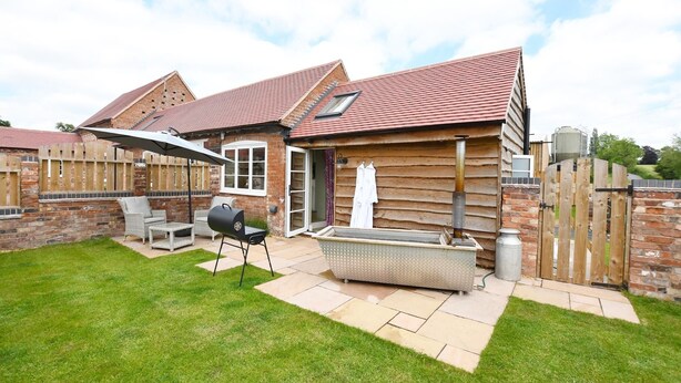 A house with a brick exterior, a tiled roof, and a fenced backyard. - Boutique Farm stay cottage in Worcestershire - Hot Tub / Dog Friendly (worcester)