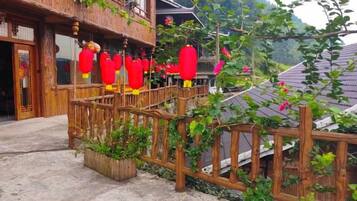 A traditional building with a wooden balcony and red lanterns.