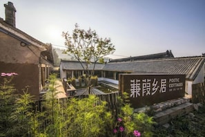 A traditional Chinese courtyard with a sign for 'Poetic Cottages.' - Poetic Cottages (Anze)