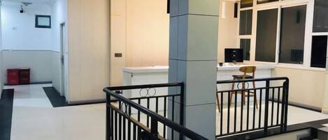 A modern interior with a staircase, a kitchen area, and a dining space.