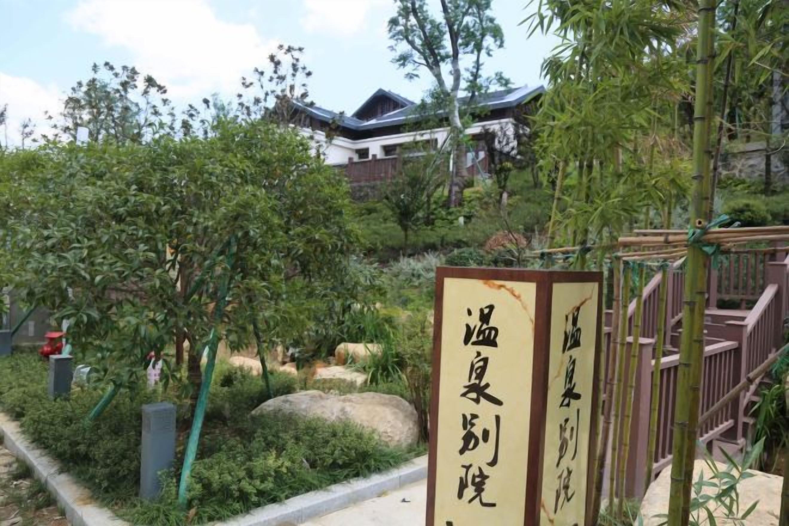A traditional Japanese building with a signboard in front.