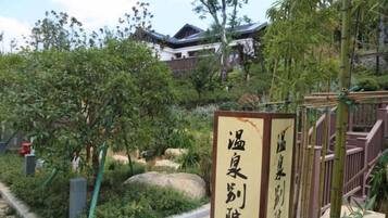 A traditional Japanese building with a signboard in front.