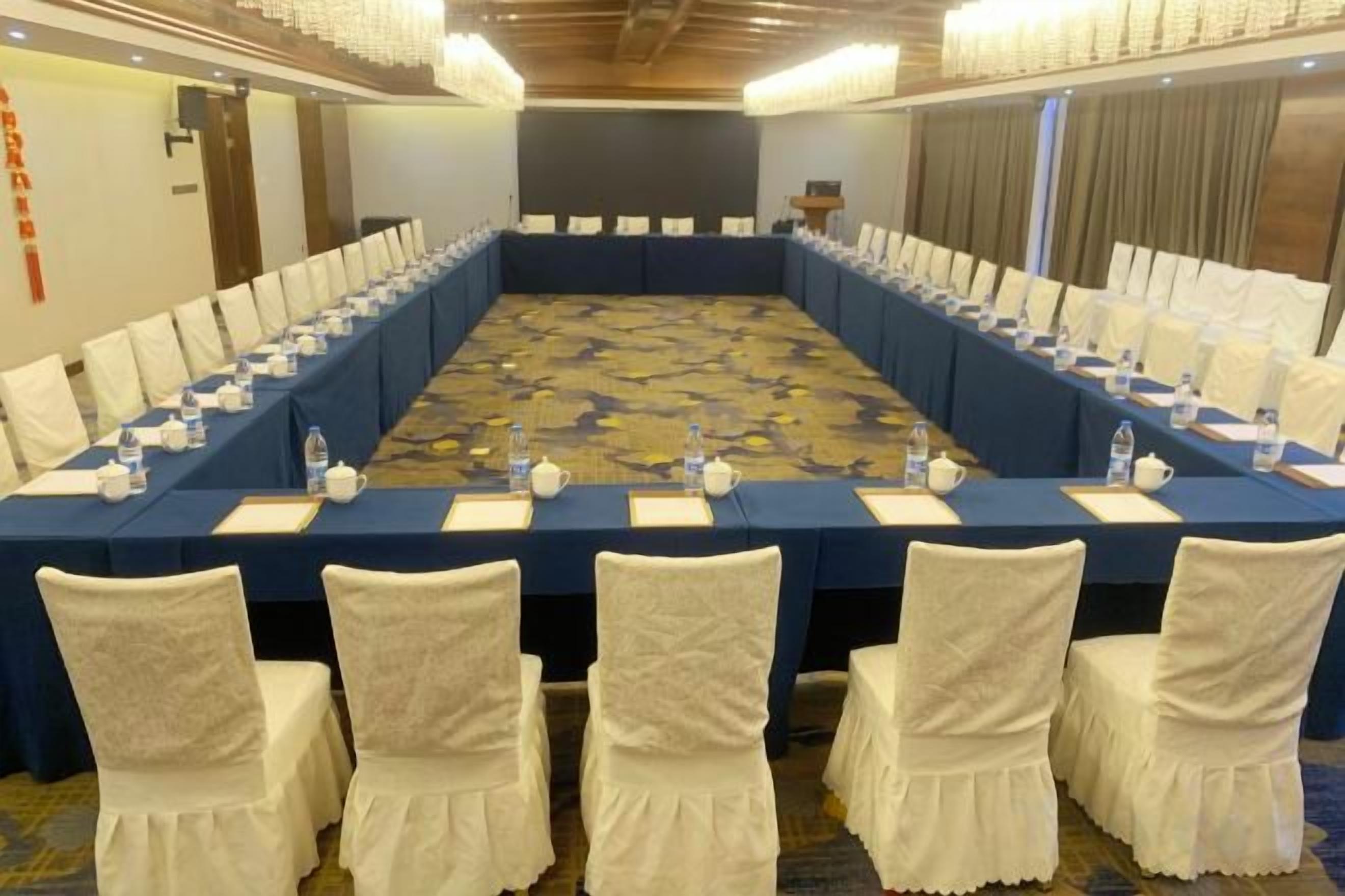 A conference room with a long table, chairs, and nameplates.