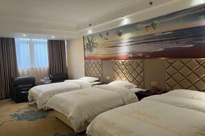 A hotel room with three beds, a large painting of a beach scene, and a view of the ocean through the window. - Xing mei da Hotel (Changsha County)