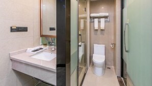 A modern bathroom with a glass shower enclosure, a white sink, and a toilet. - Oukaihua Hotel (Guilin)