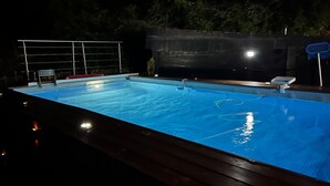 A swimming pool with a wooden deck, a metal fence, and a basketball hoop. - 'Casa Vacanze Chianti Summer' with Pool, Garden & Wi-Fi (Gaiole in Chianti)