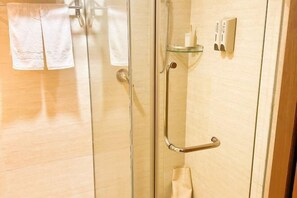 A glass-enclosed shower with a handheld showerhead, a towel rack, and a soap dispenser. - Hailian Xianggan Hotel (Yongxin)