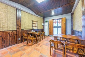 A traditional room with wooden furniture, a tiled floor, and a bamboo wall. - Chuyang Xiaoshe Hostel (Dongshan County)