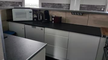 Fridge, stovetop, dishwasher, coffee/tea maker