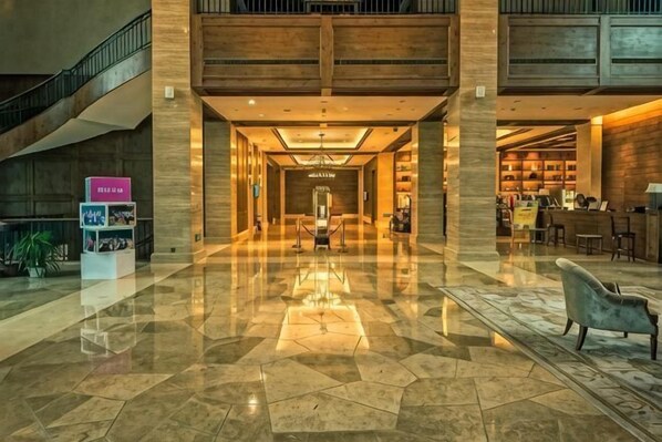 A spacious lobby with a polished marble floor, a central chandelier, and a staircase on the left. - Golf Hotel Wuhan Yishan (Wuhan)