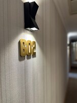 A wall-mounted sign with the number "B02" in gold letters.