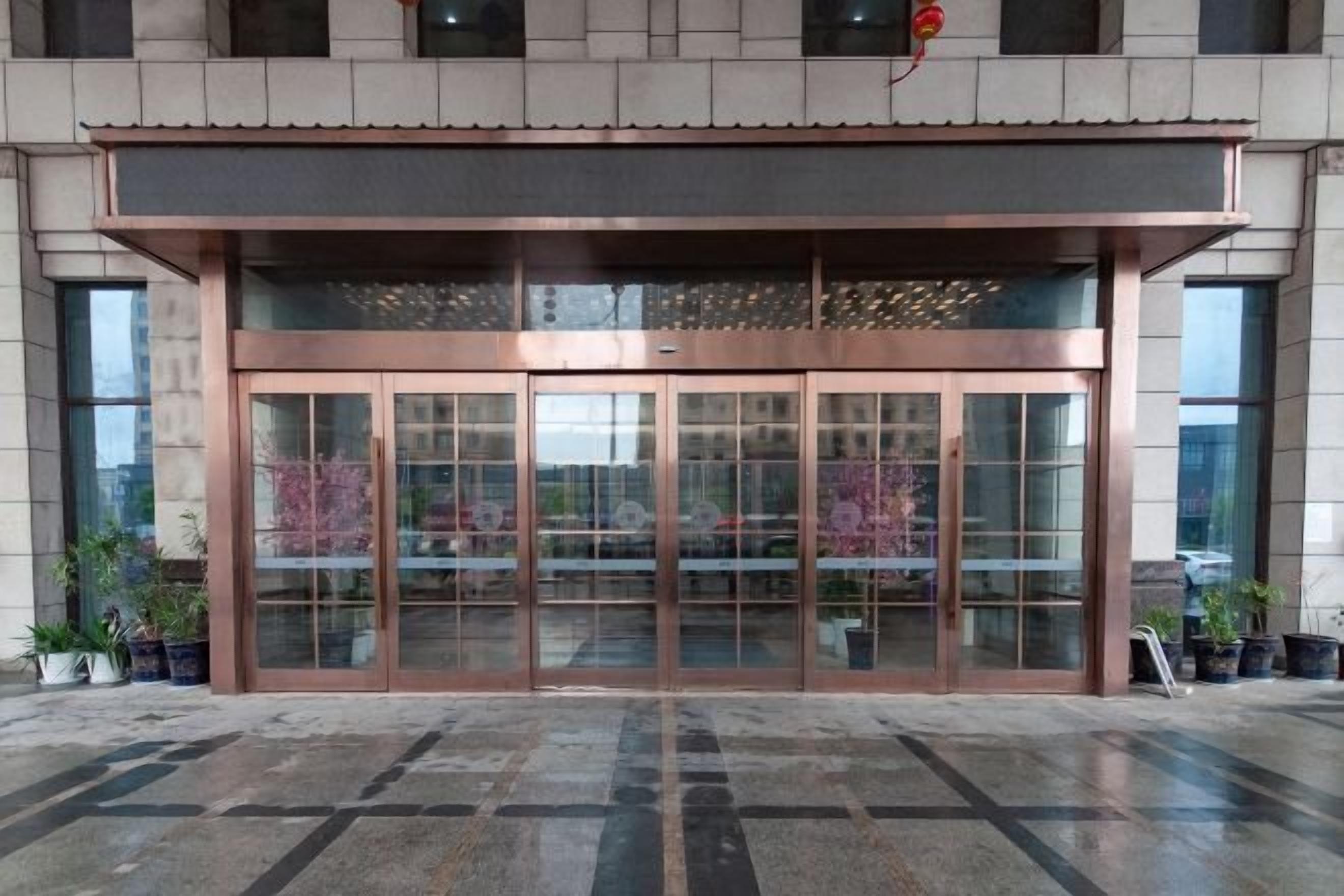 A building entrance with a glass door and a metal frame.