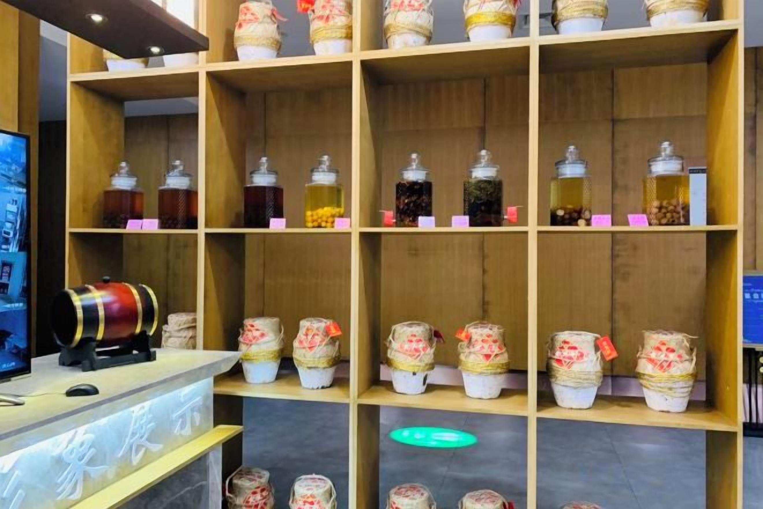 A wooden shelf with jars and a cylindrical container, likely a tea or spice display.