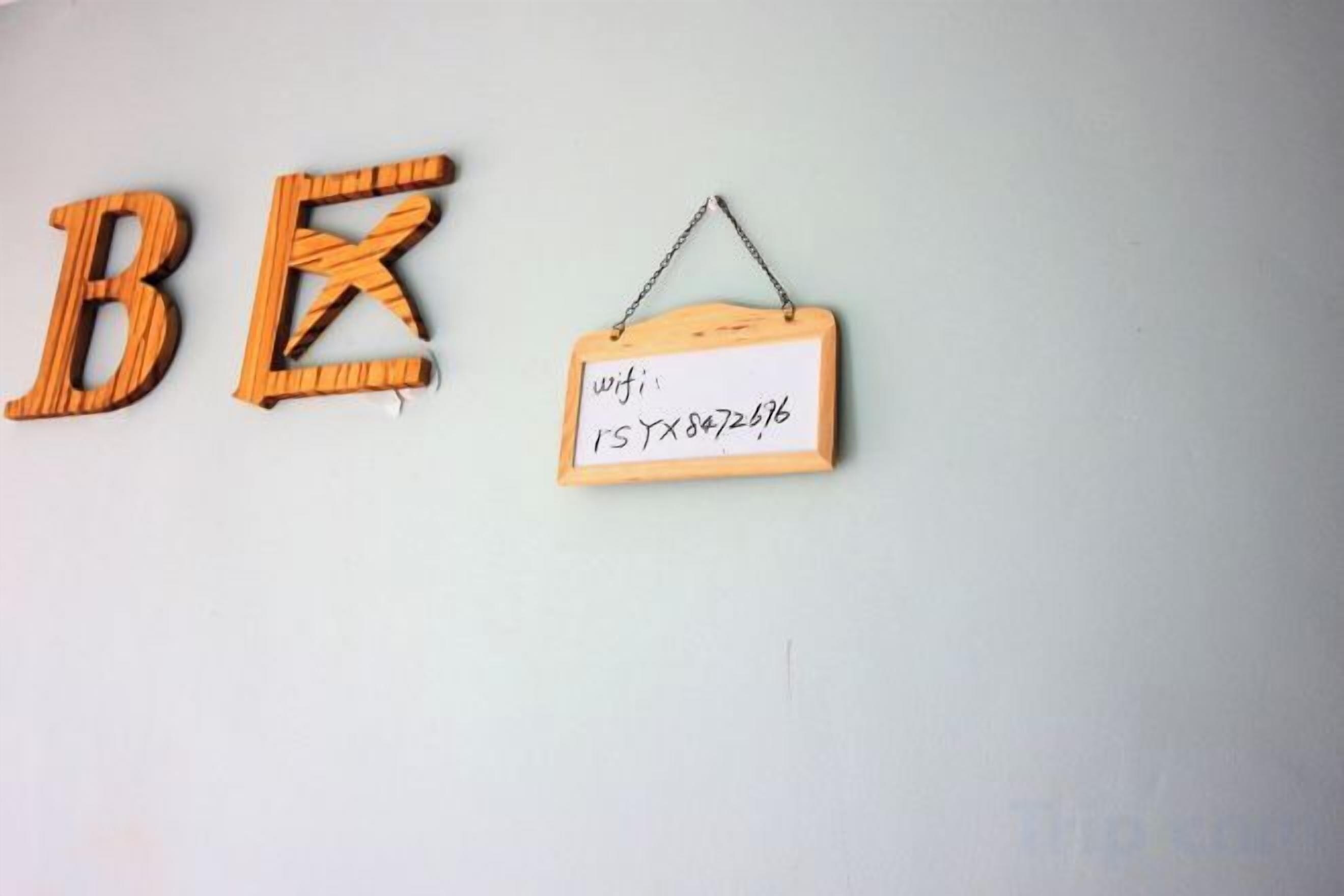 Wooden letters spelling 'BE' and a sign with a wifi password.
