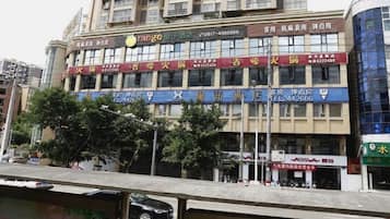 A multi-story building with commercial signage, including a restaurant and a hotel.