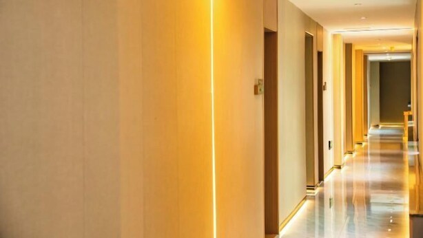 A long, well-lit corridor with a reflective floor, leading to a door at the end. - Super 8 Hotel (Xiamen Tong'an Bell Tower) (Xiamen)