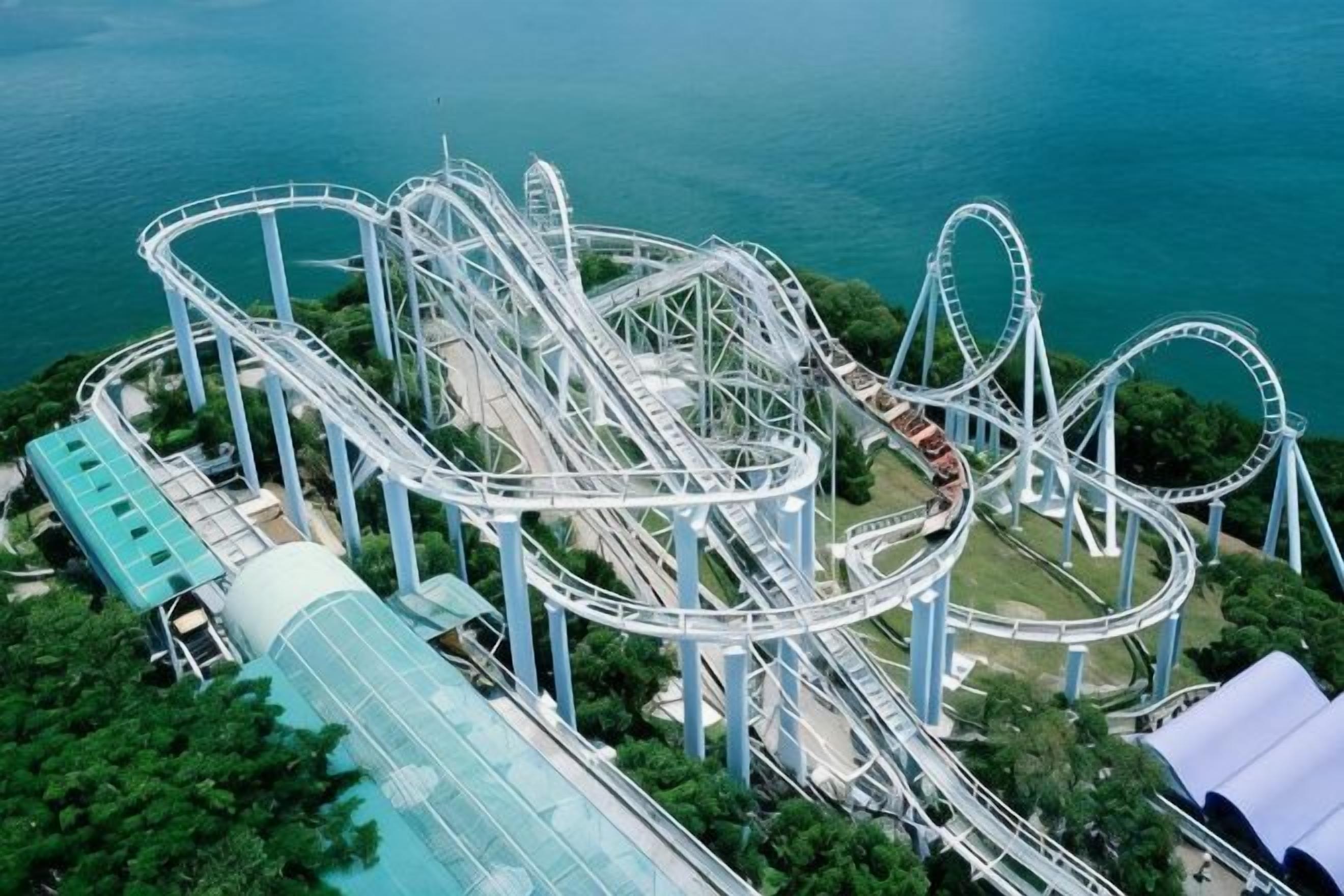 A roller coaster with multiple loops and tracks, surrounded by greenery and a body of water.