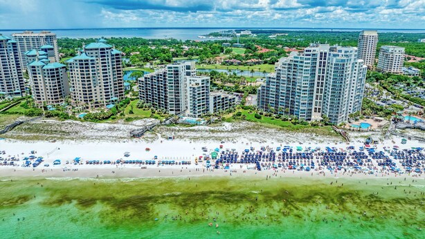 A coastal resort with high-rise buildings, a sandy beach, and a clear view of the ocean. - CostaVista-Sandestin: Steps to Beach/Gulf Views! (Miramar Beach)
