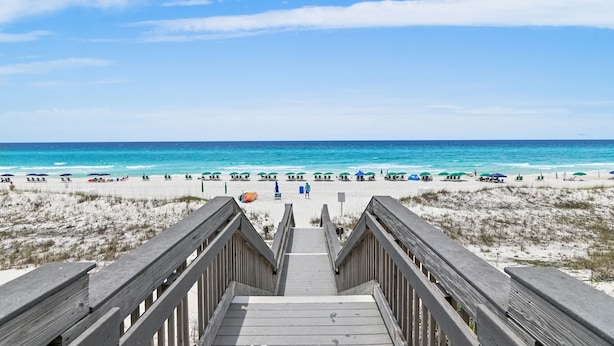 A wooden boardwalk leading to a beach with clear blue water and white sand. - Villa Coyaba 306 | Private Beachfront | Includes Daily Beach Setup | Pool (Destin)