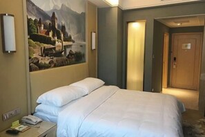 A hotel room with a bed, a nightstand, a painting of a landscape, and a door to another room. - Vienna Hotel (Ji'an County Yanjingfu) (Ji'an County)