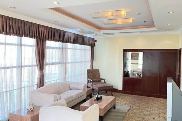 A modern living room with a sofa, armchairs, a coffee table, and a large window with curtains. - Tianhaoyuan Country Club (Beijing)