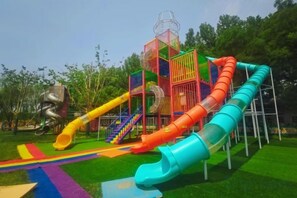 A playground with multiple slides and a climbing structure. - Tianhaoyuan Country Club (Beijing)
