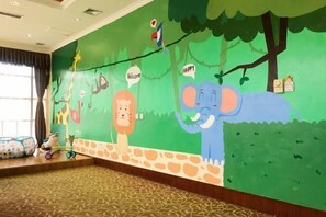 A children's play area with a mural of animals and a slide. - Tianhaoyuan Country Club (Beijing)