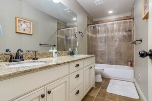 Combined shower/bathtub, towels, soap, toilet paper