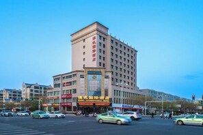 A multi-story hotel with a prominent entrance and signage.