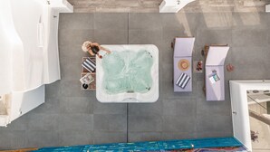 A rooftop pool area with a hot tub, lounge chairs, and a tiled deck. - Mariet Naxos Elegant Suites (Naxos)