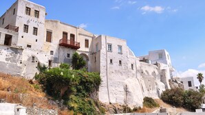 A historic building with multiple balconies and a rugged facade. - Mariet Naxos Elegant Suites (Naxos)