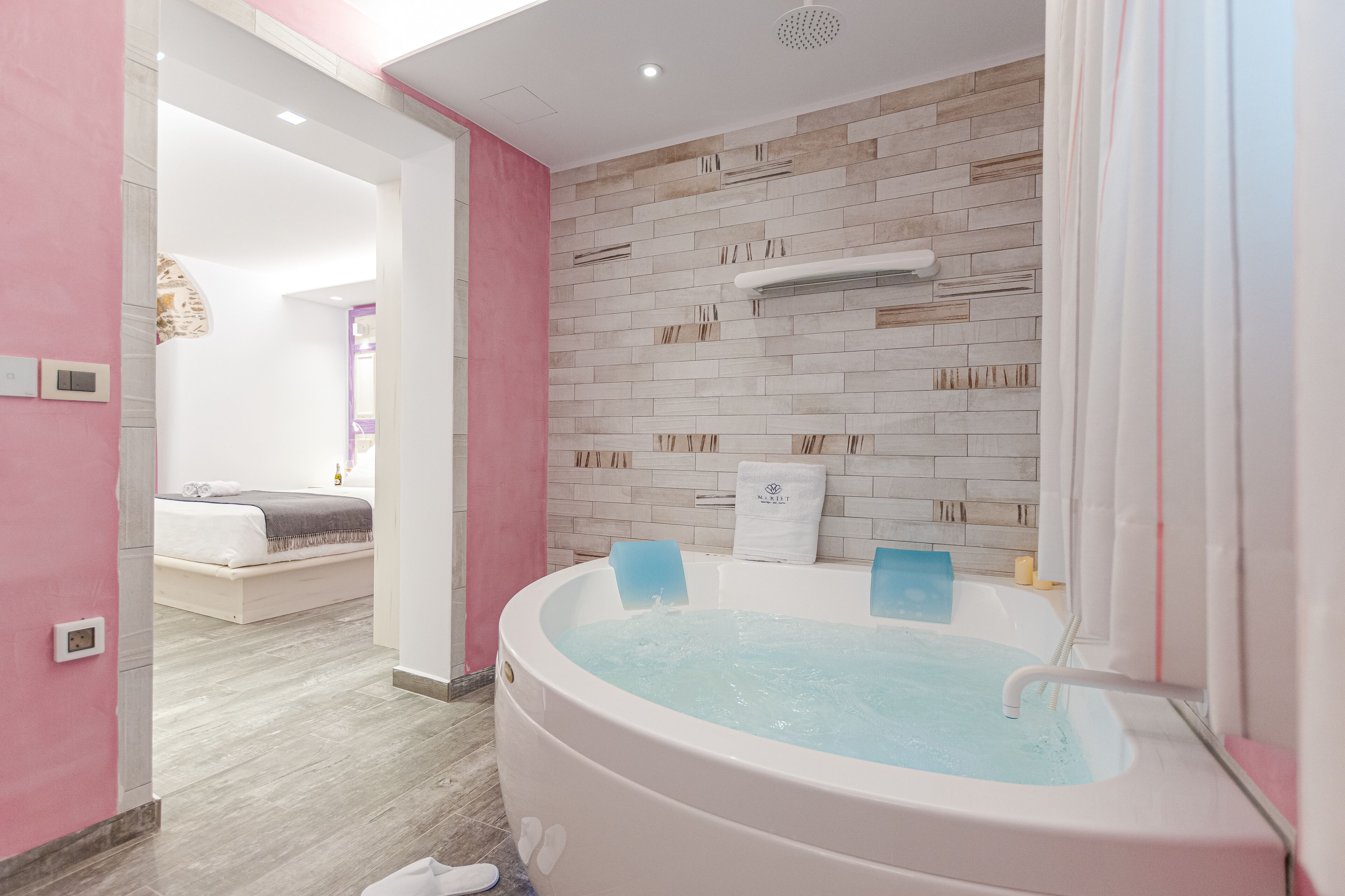 A modern bathroom with a large bathtub, a shower area, and a visible toilet.