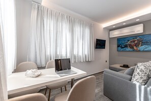 PETRA SUITE, PARTIAL CITY VIEW | Living area | 32-inch Smart TV with satellite channels, TV, smart speakers - Mariet Naxos Elegant Suites (Naxos)