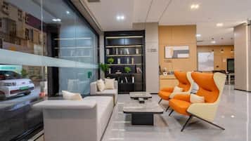 A modern interior with a seating area, a bookshelf, and a television.