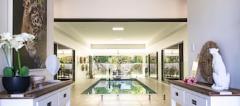 Luxury Tropical Escape: Beachside Villa with Heated Pool & Modern Comforts
