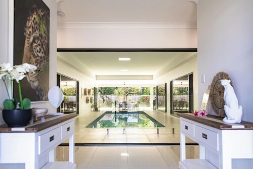 Luxury Tropical Escape: Beachside Villa with Heated Pool & Modern Comforts