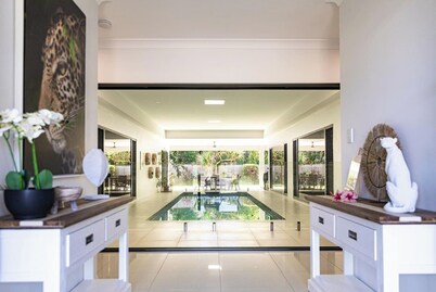 Luxury Tropical Escape: Beachside Villa with Heated Pool & Modern Comforts